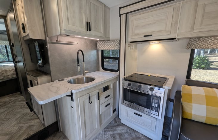 Spacious, bright & modern interior. Well-stocked kitchen with stove-top and convection microwave. Comfy couch and dinette both convert to beds. Large overhead bunk with swing-out TV for entertainment.