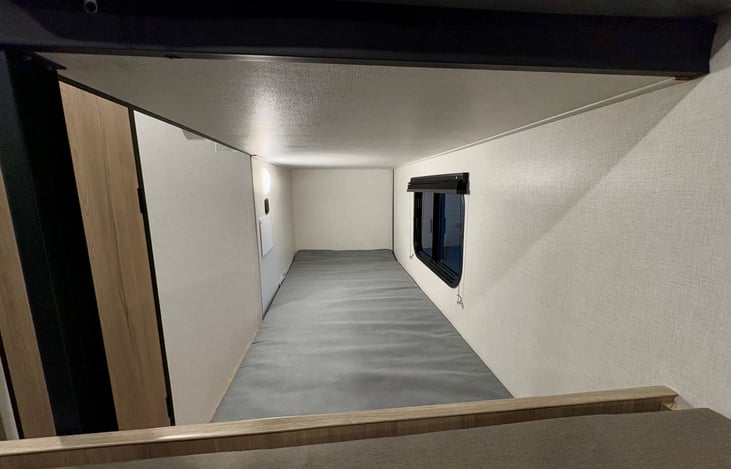 Bottom bunk with light, window and outlet