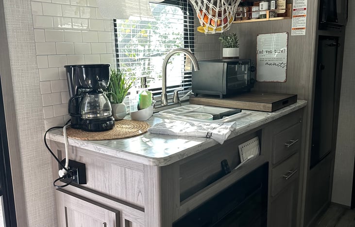 toaster oven, microwave, fridge, stove, electric 2 burner plug in, electric griddle, pancake maker, blackstone grill, pots, pans, dishes