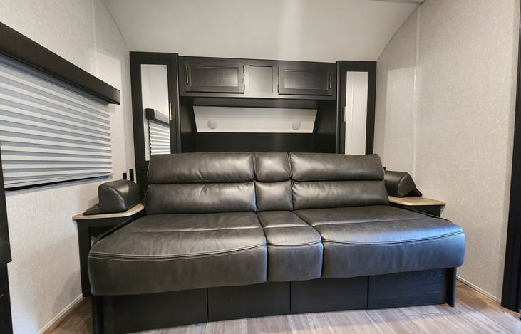 Sofa that faces the kitchen and dining area- Sofa also converts into a short Queen bed that sleeps 2 guests comfortably with 6ft of length space