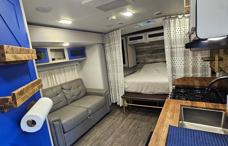 Step inside the Blue Wanderer — where cozy comfort meets the open road