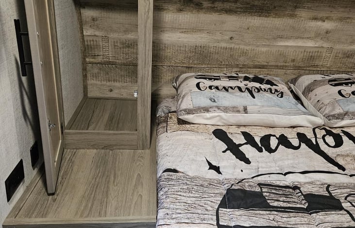 Storage compartments are located on both sides of the bed for clothing, etc.