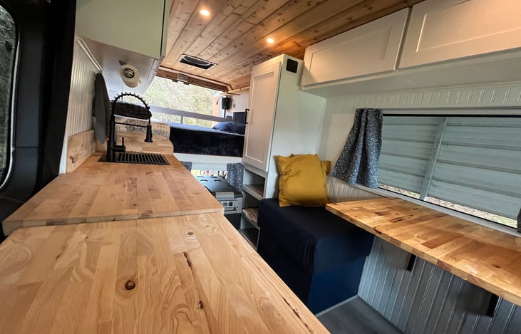 Hidden under the custom upholstered bench is a composting toilet, best used for off-grid campers.