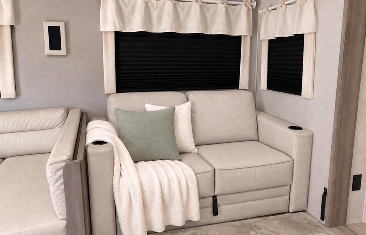 Comfortable reclining sofa with a cozy fireplace and TV nearby — perfect for relaxing after a day of adventure.
