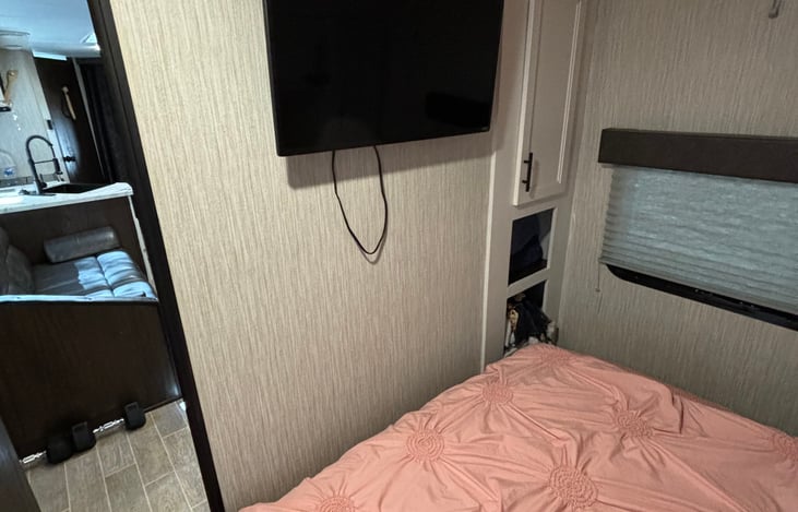 Primary bedroom tv and door