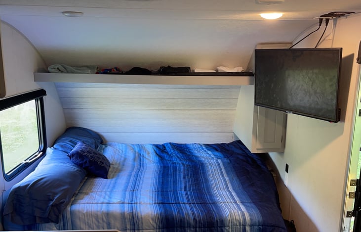 Queen size bed with mattress topper, mounted TV with DVD player built in