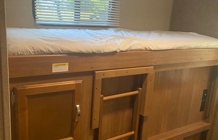 Single bunk with ladder access that folds up when not in use.