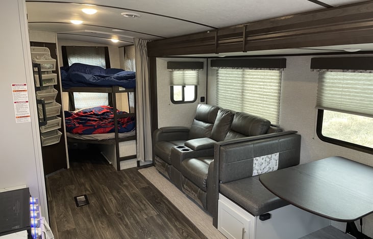 Double over double bunk beds, reclining theater seating and dinette area