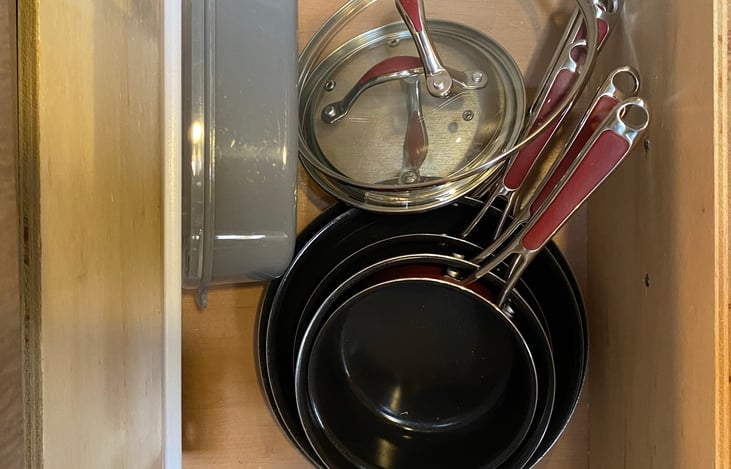 Non-stick cookware, cutting board, and nesting microwavable storage containers make cooking easy.