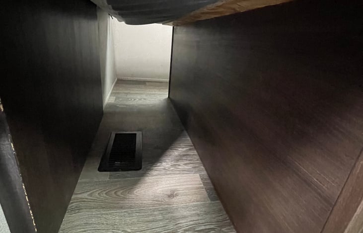 Storage area under master bed.