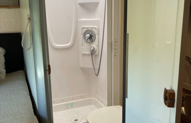 Full size shower and nice toilet. We're both tall and and find the shower fairly roomy for an RV