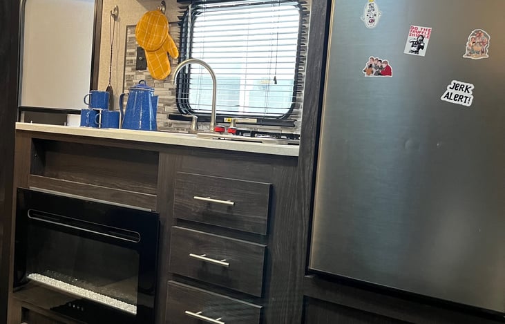 fridge with microwave in top.   Fireplace to the left.  Do the trufle shuffle!