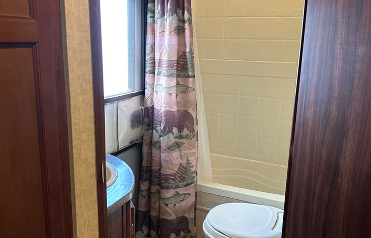 Curved curtain rod for more room while in the shower