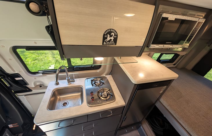 Well equipped kitchenette with fridge, stove top and microwave.