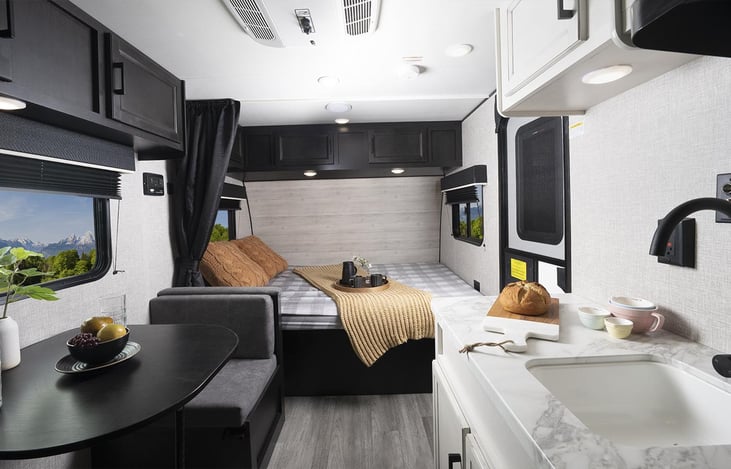 Cozy up in the front Queen bed. Windows on both sides provide views during the day and blinds allow for privacy at night. Overhead storage cabinets take advantage of unused space.