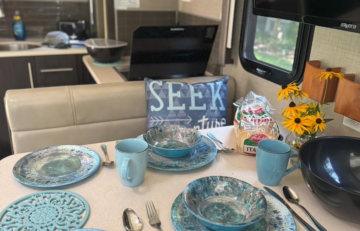 Setting and silverware for 4 with lots of cooking utensils