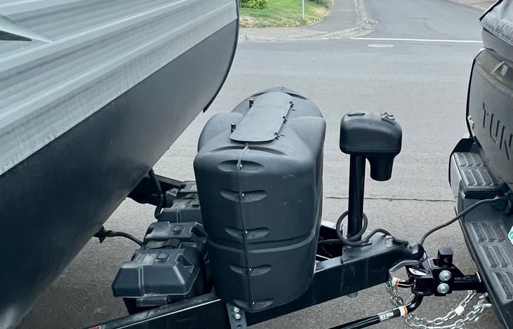 Raise and lower with the push of a button.  Propane tanks and batteries