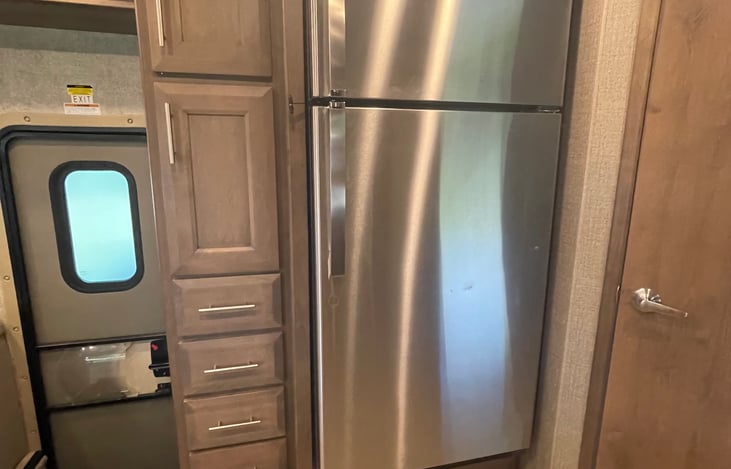 Residential size fridge...big enough for a week's worth of groceries. Plenty of storage on the side too. RV includes plastic place setting for 6 and silverware. Cookware includes spatulas, cutlery, et