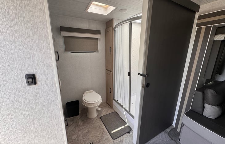 Large walk in bathroom and shower with skylight and fan