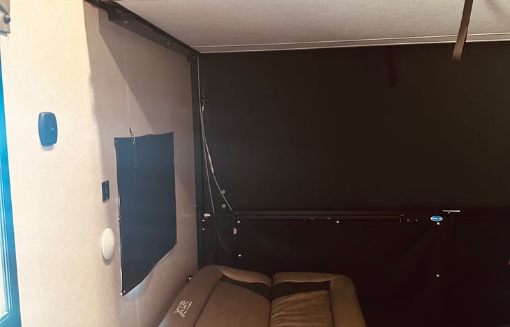 Garage with bunk bed on top and 2 sofas