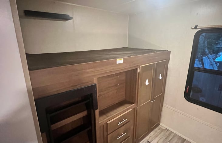 Bunk #2 with ladder and ample storage.