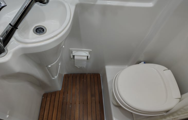 Bathroom sink and flush toilet. 14 gallon black tank capacity.