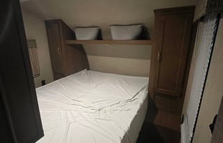 Camper with a queen living space and a bunkhouse.