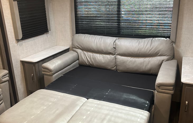 Couch in living room folds to bed.
