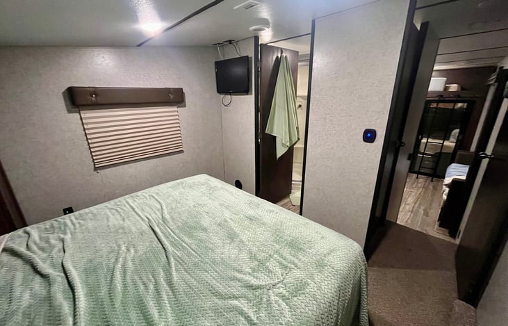 Main bedroom. Sleeps two adults comfortably. TV and walk in bathroom access for convenience.