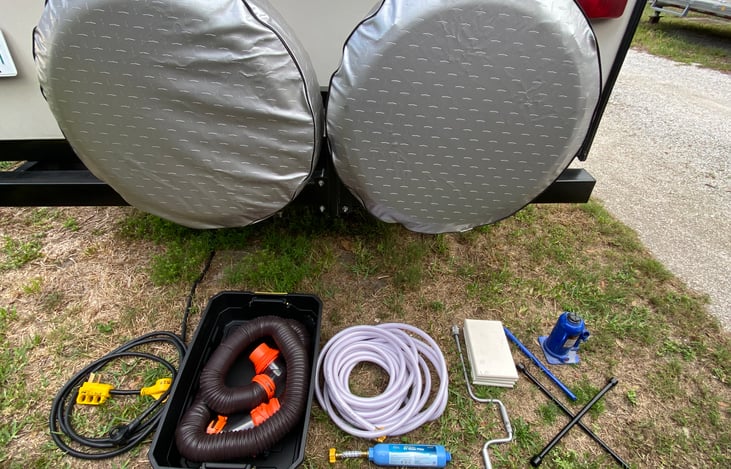 Camper equipped w/ 2 spare tires, 4-way tire iron, 12-ton bottle jack, 30 amp cord, 30 amp to 50 amp power adapter, freshwater hose, freshwater hose filter, stabilizer jack crank, stabilizer jack pads