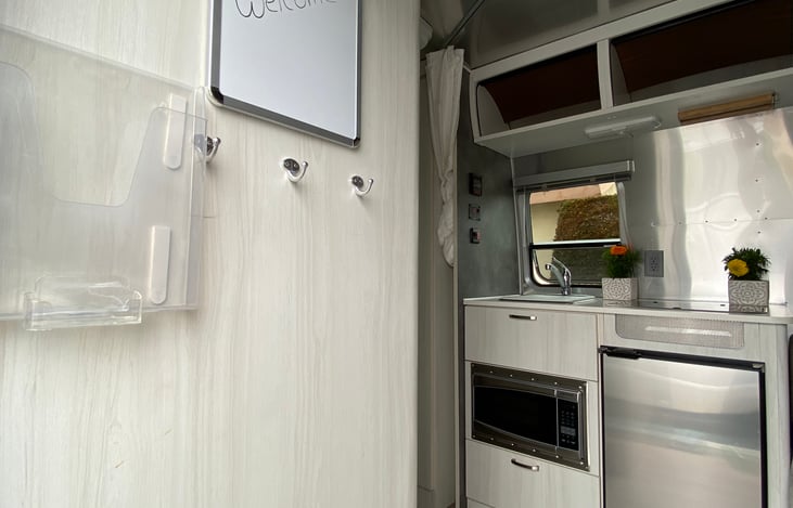 Kitchen with sink and stove, microwave and refrigerator, and lots of storage