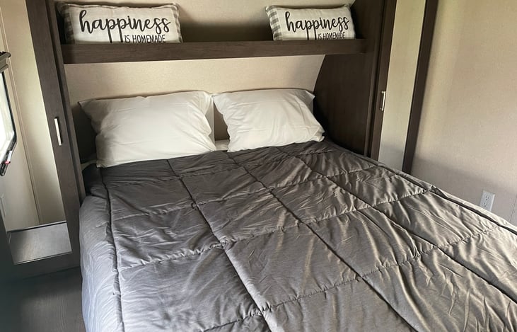 Upgraded queen bed area with privacy door.