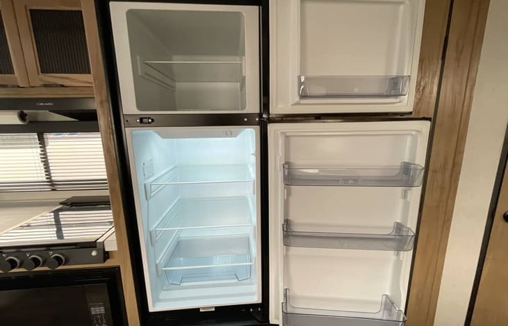 Spacious refrigerator and freezer with generous shelving for food storage