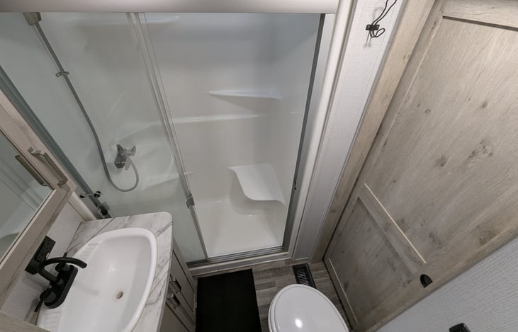 Experience a spa-like retreat with a walk-in shower, porcelain toilet, and spacious vanity. Large medicine cabinets provide ample storage, making this private master ensuite a true luxury upgrade.