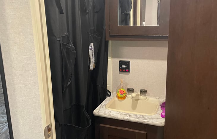 Full bathroom, not typical in a toy hauler this size.