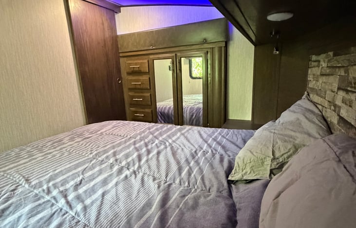 Queen bed with 8" gel bed for optimal comfort pillows and bedding provided. Wardrobe view with mirros