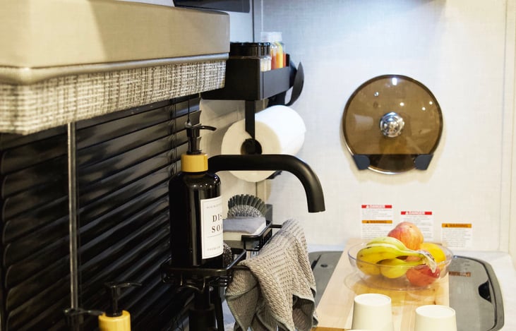 Use the large cutting board on top of the flush glass stove cover to prep food and utilize the space to its max. The role out rack on top of the sink is a huge space saver when drying dishes.