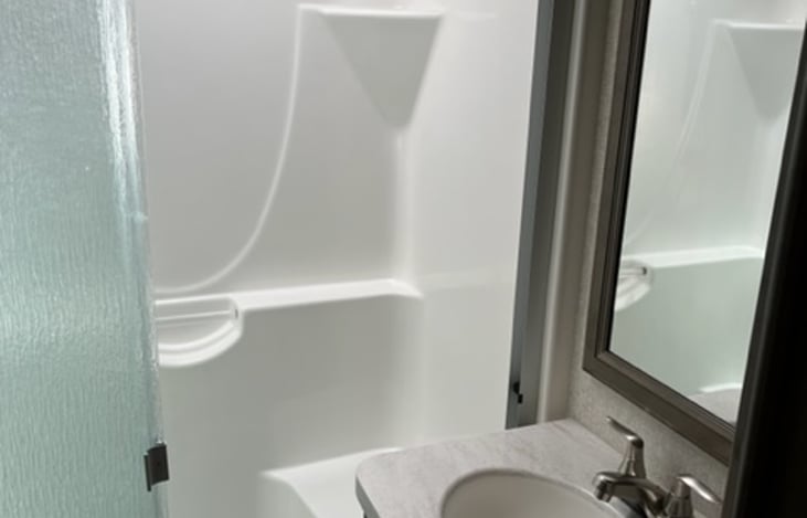 Full size bathroom. Shower, toilet, cabinets and sink.