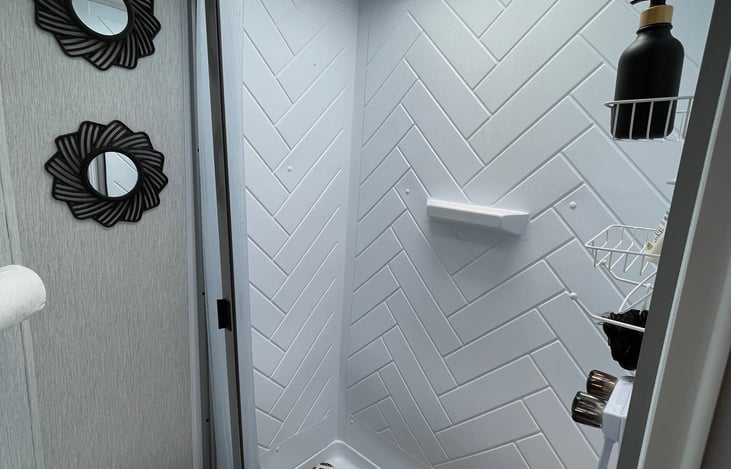 BATHROOM HAS NATURAL LIGHTING UP ABOVE AND VENTELATED EXHUAST FAN ALL WITH A FLIP OF A SWITCH