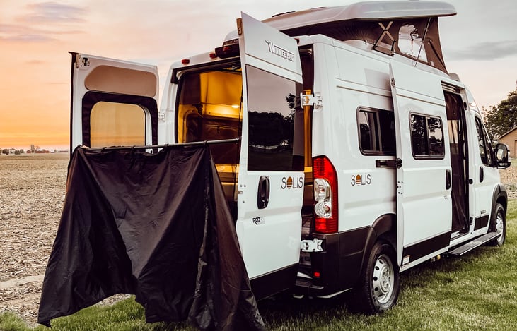 Outdoor shower curtain and rod included. Magnets also provided to better secure curtain to rear doors.