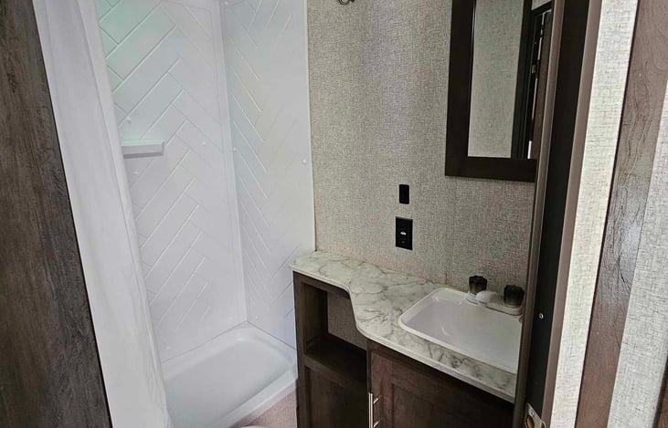 Bathroom, includes toilet, sink, and shower.