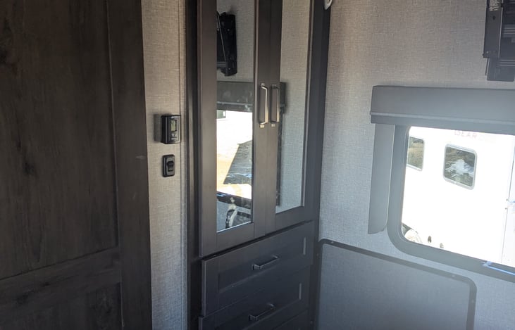 Hanging closet with several built in drawers.