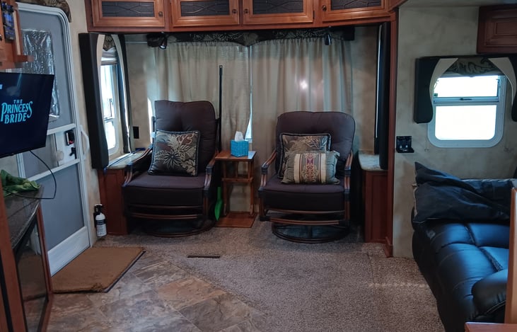 Several comfortable seats for reading, watching television, and relaxing.  Large windows grant access to the view of your campsite; all blinds can be drawn for privacy.