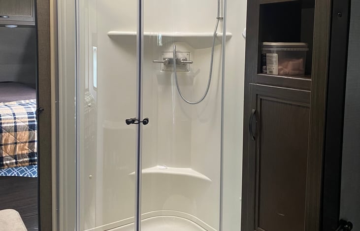 Full size shower with skylight for extra headroom