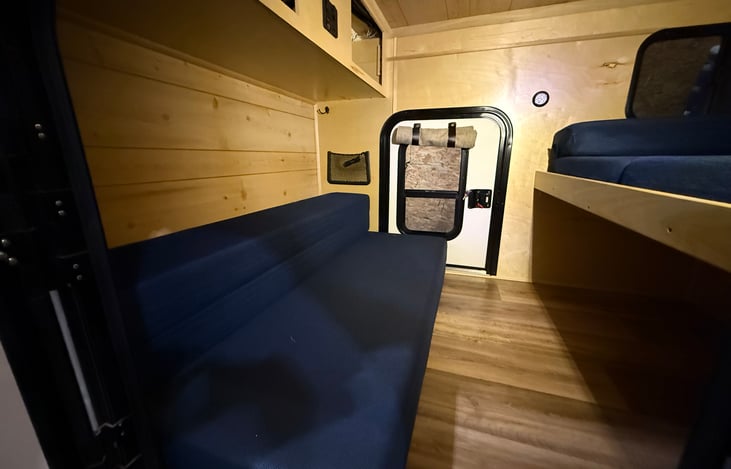 Queen mattress folded into seating area while out of the elements. Great place to store additional items while traveling.