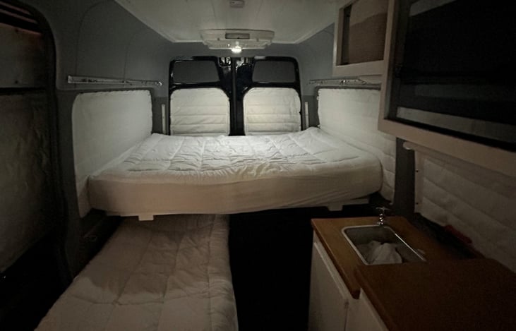 Top bed is fixed install- big enough for 2. Bottom is just an extra cot we have.