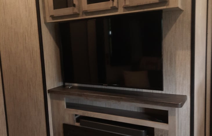 Living room TV with fireplace.