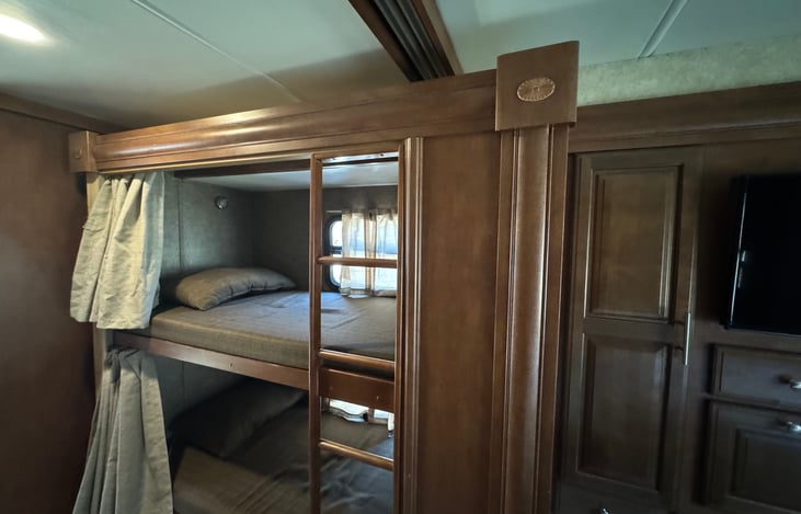 Twin bunks with private TVs.