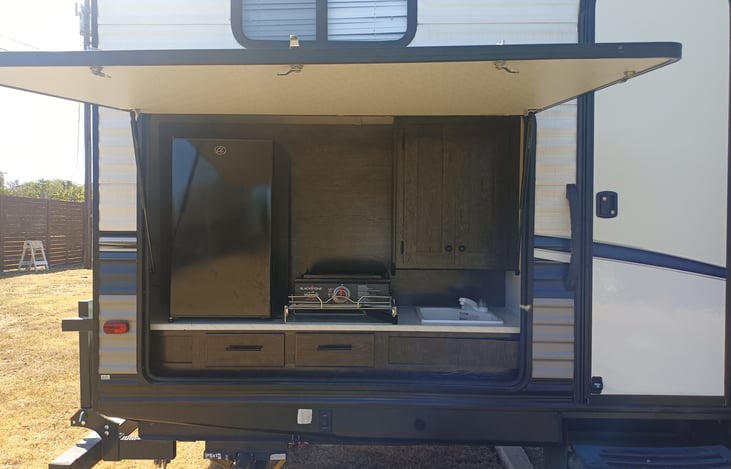 Outdoor Kitchen includes refrigerator, Blackstone 17" Griddle, sink, cabinets, and 2 drawers