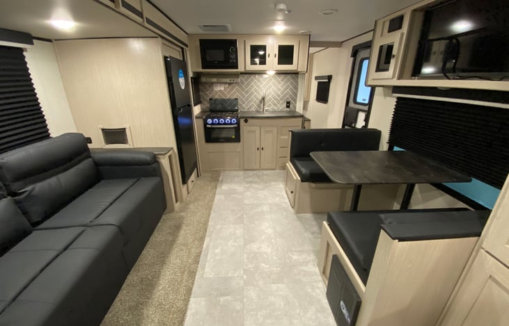 Rear to front view of living, diving, and kitchen area with bedroom in the front